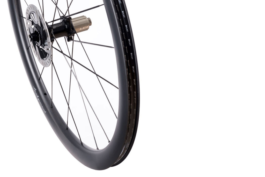 Up close image of the HUNT 44 UD Carbon Spoke Disc rear wheel, showing the detailed rim and hub design