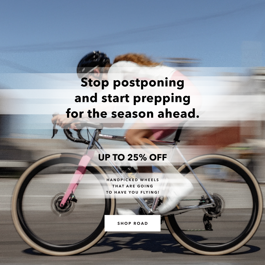 Cyclist racing on chrome and pink bike with HUNT 25% off discount text