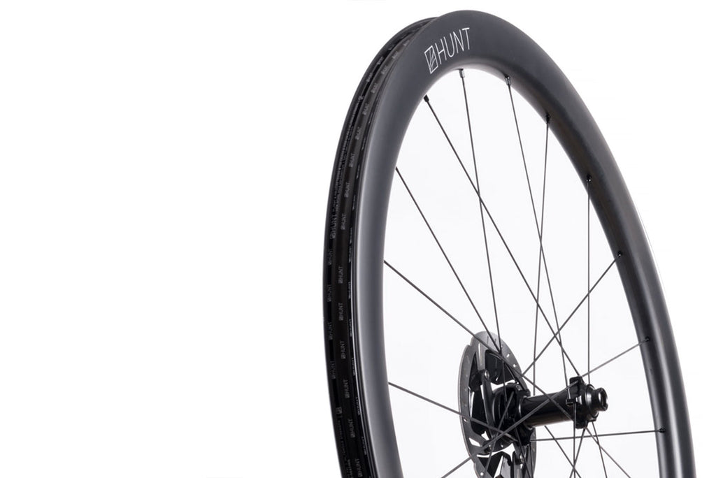 Up close image of the HUNT 4454 Aerodynamicist Carbon Disc front wheel, showing the attention to detail in the design