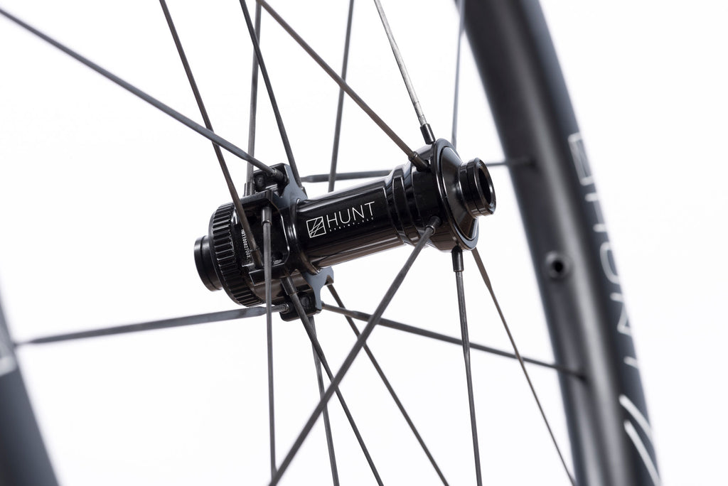 Detailed photo of the front hub of the HUNT 48 Limitless UD Carbon Spoke Disc wheelset, showing the detailed manufacturing specs involved in the hub
