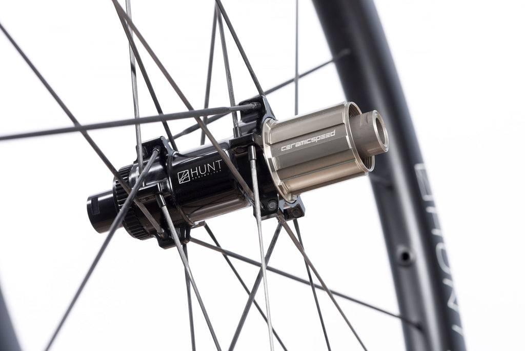 Detailed photo of the rear hub of the HUNT 48 Limitless UD Carbon Spoke Disc wheelset, showing the CeramicSpeed components included to make the wheel as fast and efficient as possible